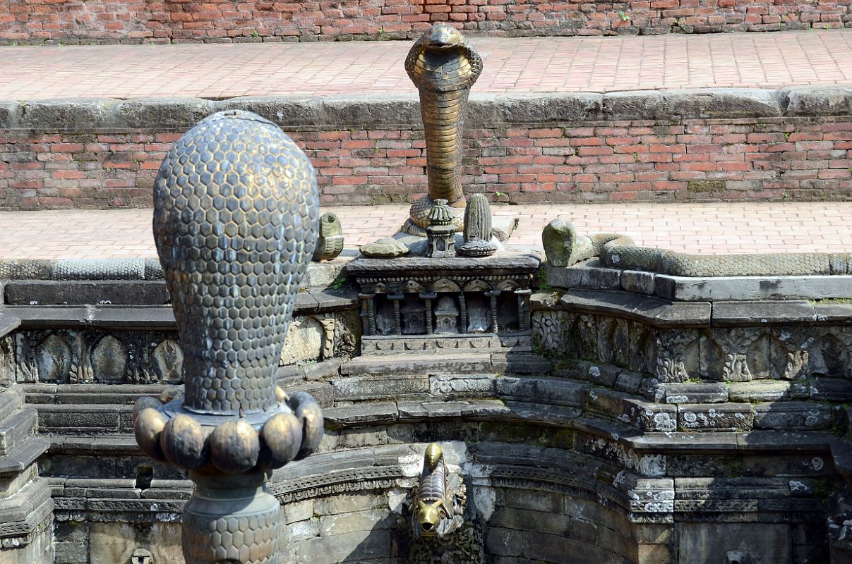 Kathmandu Bhaktapur 05-3 Bhaktapur Durbar Square Naga Pokhari Cobra Heads Close Up Naga cobra heads face each other in the Naga Pokhari in the Palace of 55 Windows in Bhaktapur�s Durbar Square.